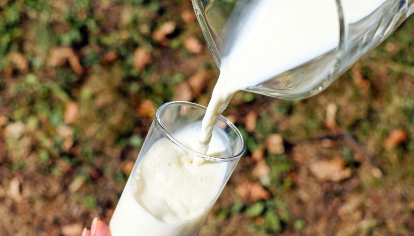 A picture of milk being poured from a jug into a glass, with the caption that a litre a day equals a tonne per year of CO2 emissions
