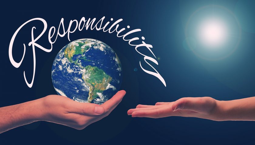 A picture of a hand holding planet earth, with the word "responsibility" around it handing it over to another hand waiting to receive it.